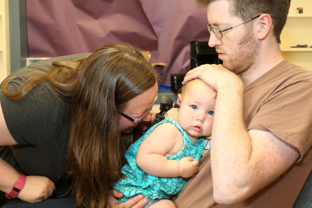 A young baby participating in an audiology evaluation